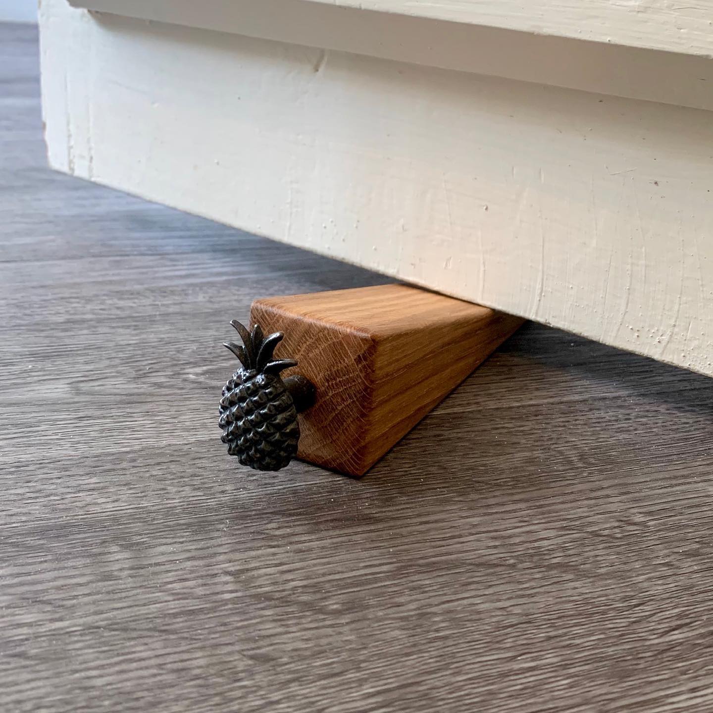 SALE! - Dark grey metal Pineapple Door Wedge NOW £9 plus shipping Available on our website- follow the link in our bio Made from solid oak, this is a lovely addition to any home, a unique and useful gift! .#homedecor #valentine #somethingunique #pineapple #oak #madefromwood #design #handmade #gingerandtweed #madeinwiltshire #cottagelife